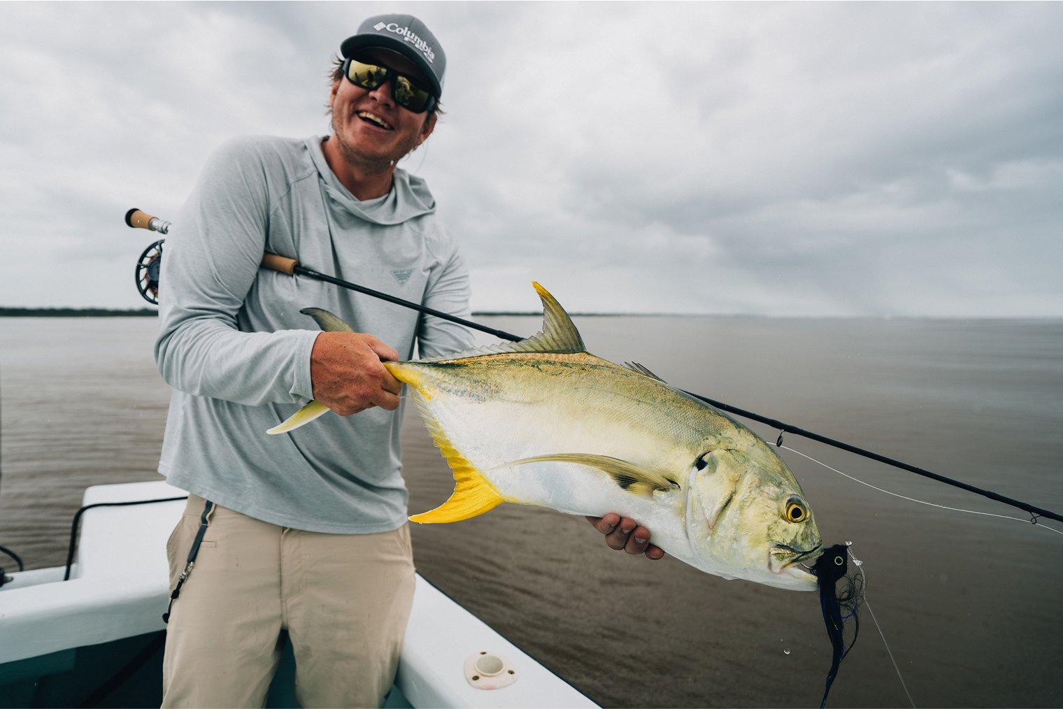 Man smiling holding a big fish.