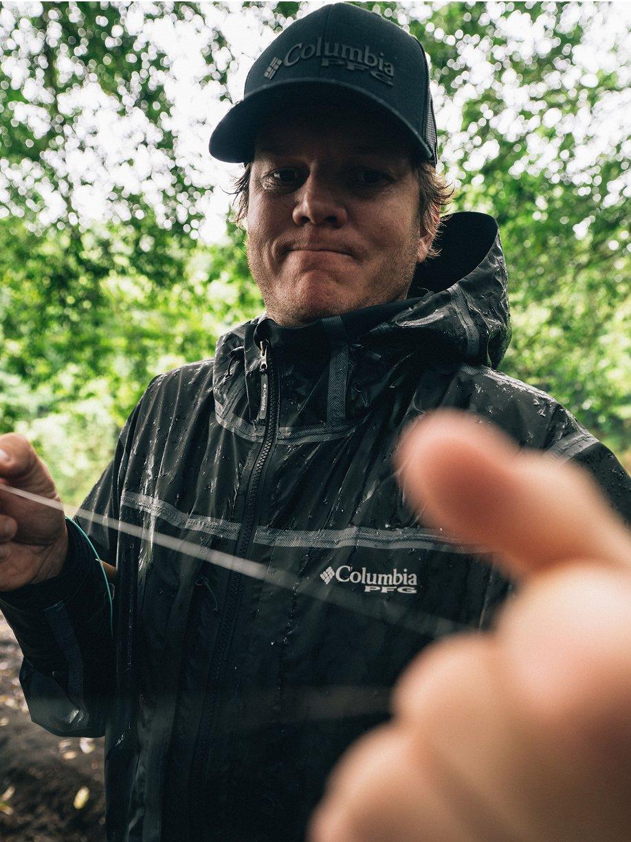 Man with a tough look on his face in a waterproof jacket.
