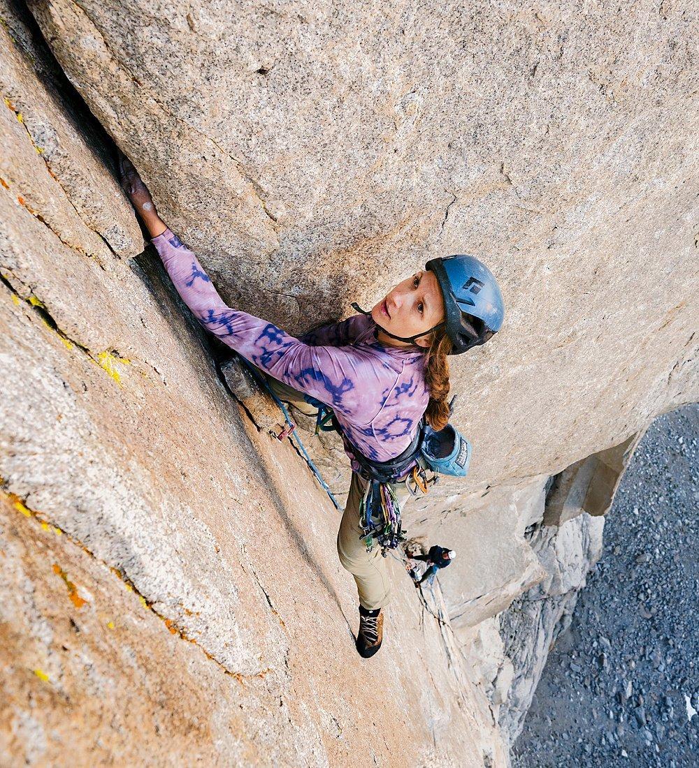 A female climber making her way up a route.