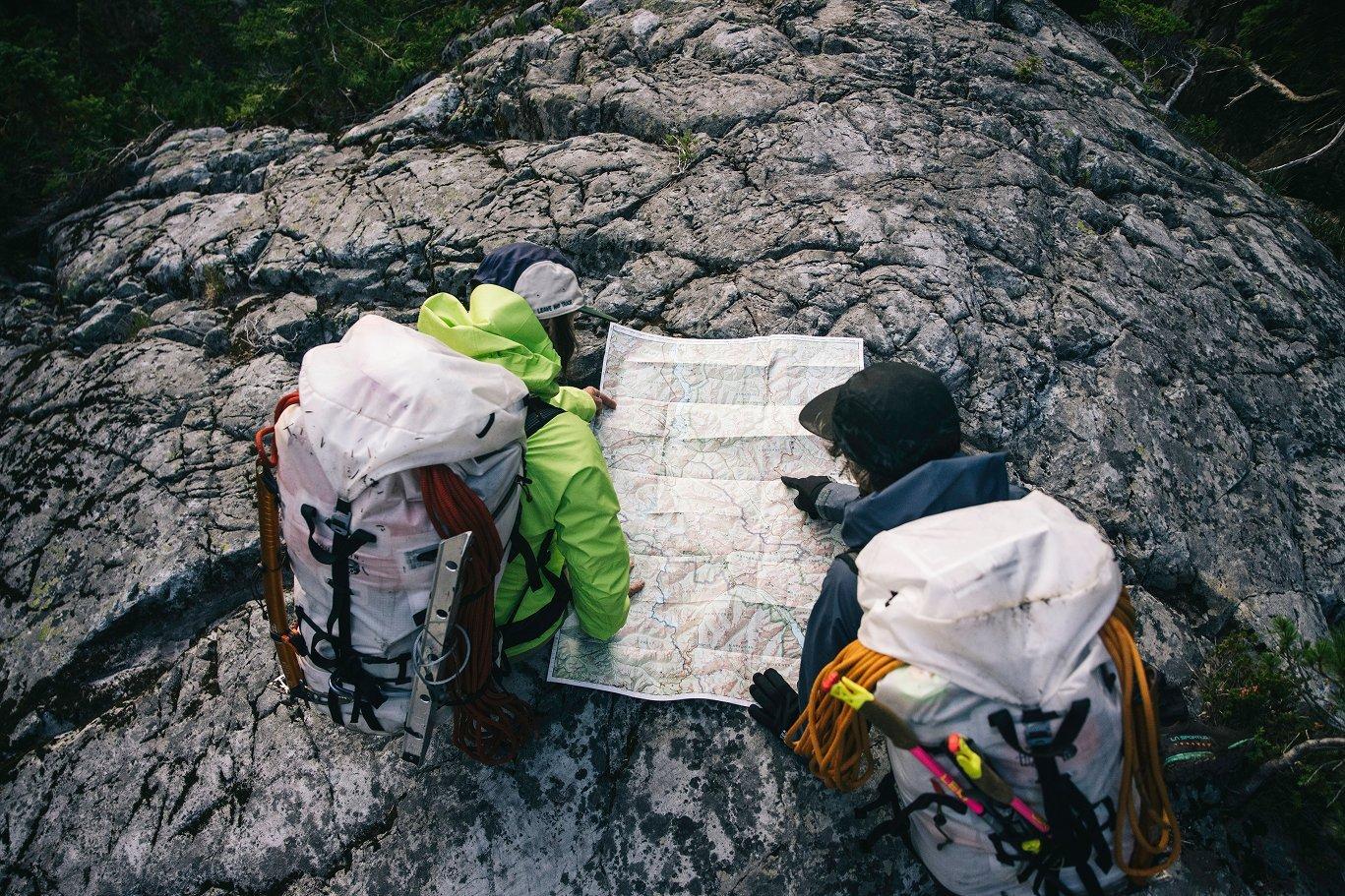 Navigating the map while on the backpacking trip.