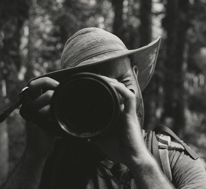 Portrait of Andy Cochrane behind a camera.