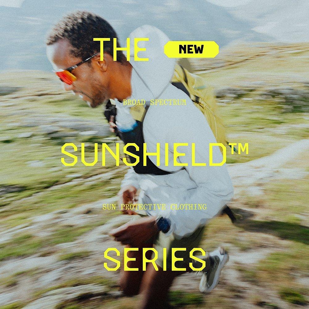 The New Broad Spectrum Sunshield™ Sun Protective Clothing Series type overlaid on a trail runner running in the mountains wearing the Sunshield™ Hoody.
