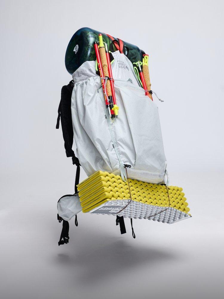 An Alakazam™ Backpack floats mid-air, loaded with a visible bear canister and sleeping pad.

