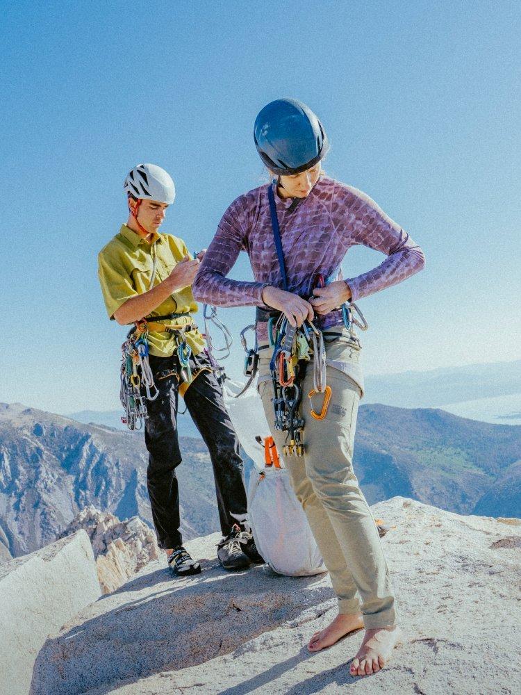 Two climbers in a Men’s Sun Drift™ Cooling Short Sleeve Shirt and a patterned Women’s Crater Lake Long Sleeve.