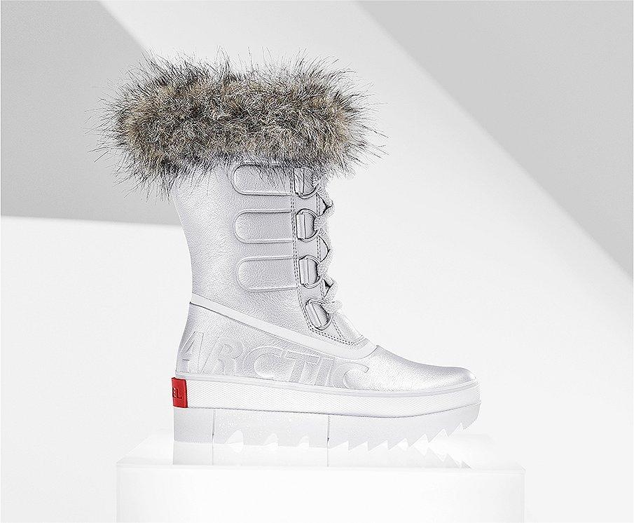 A profile view of a silver Joan NEXT boot on white background