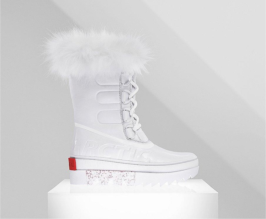 A profile view of a white Joan NEXT boot on white background