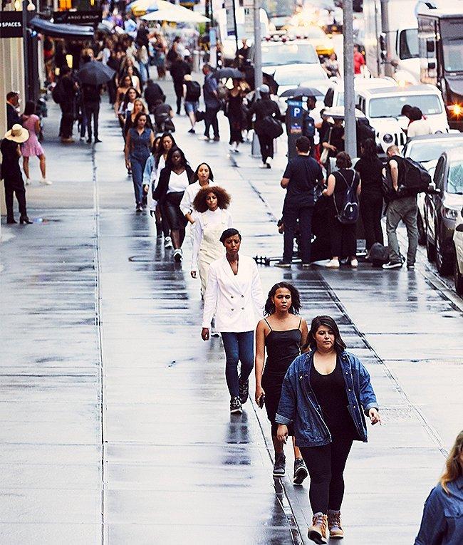A row of women wearing the Blake Lace boot on an urban street