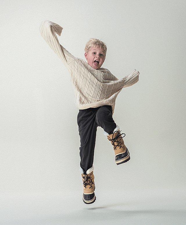 Image of child with SOREL boots on