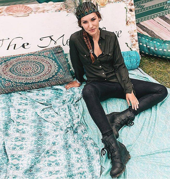 A woman wearing the JOAN™ RAIN WEDGE shoe