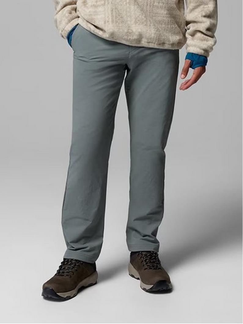 Waist-down image of a man wearing tan pants and sneakers with text: Bottoms