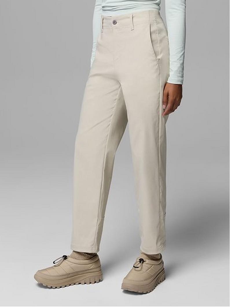Model wearing beige chino pants paired with a light blue long-sleeve top and tan hiking shoes.