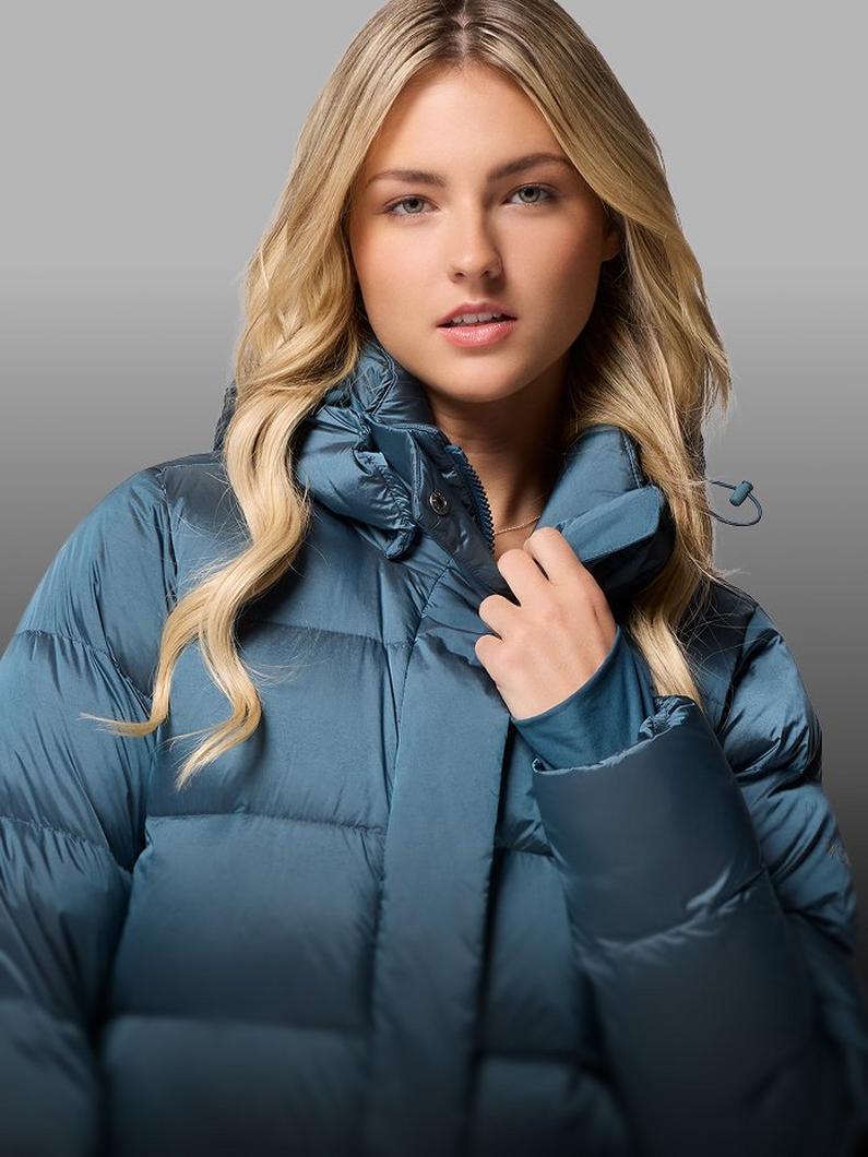 A woman wearing a blue puffer jacket