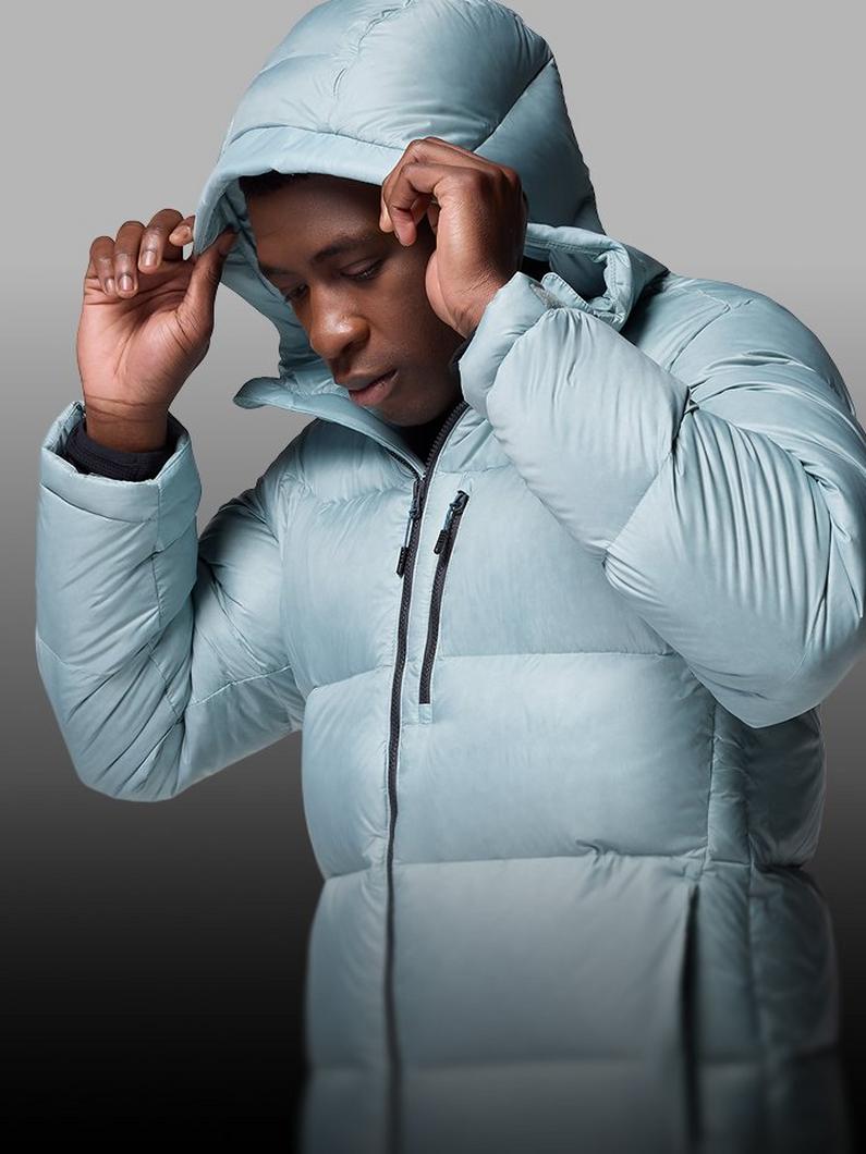 A man putting up the hood of light blue puffer jacket