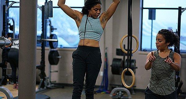 Two female climbers training in the gym