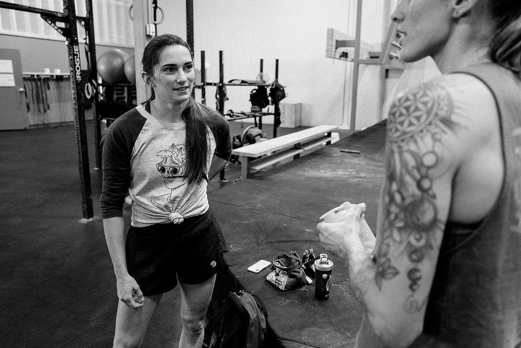 
Black and white image of Kyra and Alex talking in between climbs at the gym
