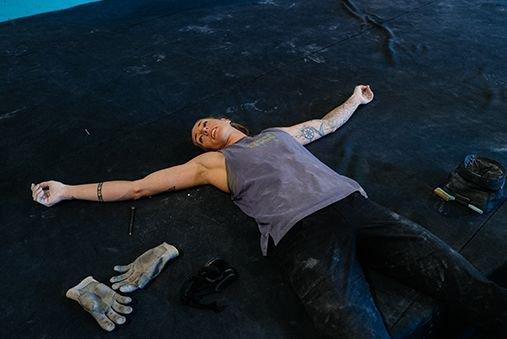 Alex taking a break, sprawled out on the floor of the gym