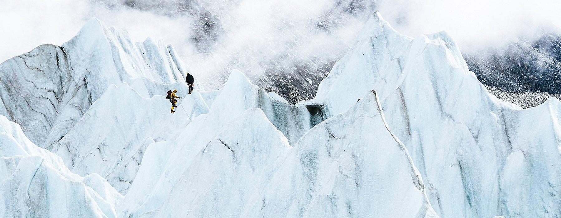 Image of Garrett Madison and Tim Emmett product testing future Absolute Zero Suits in the glacier fall near Everest Base Camp.