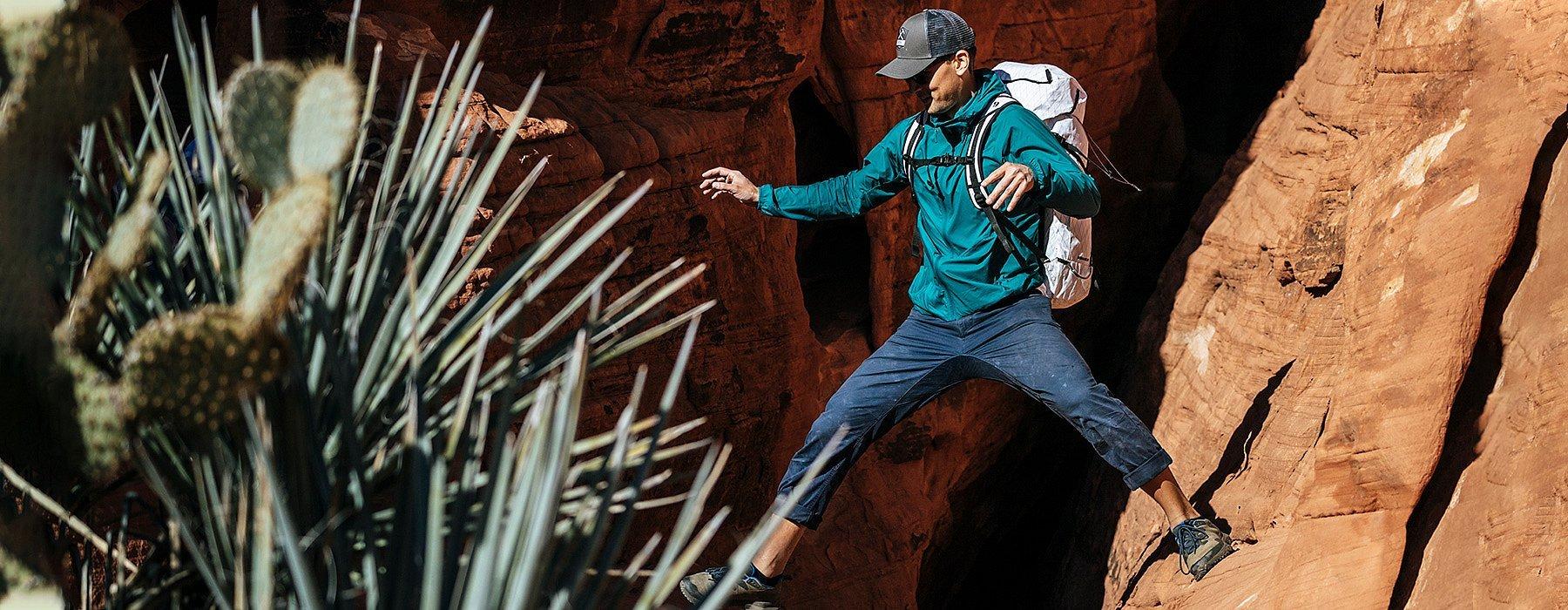 Men's Kor Preshell™ Hoody in action, climber straddling between rocks
 