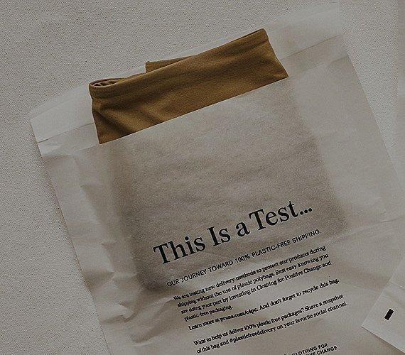 An image of a prAna product in a recyclable paper bag represents responsible packaging. 