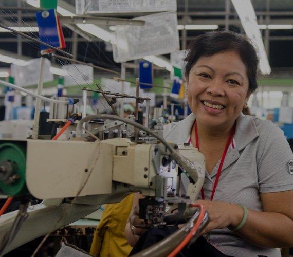 An image of a woman working on a sewing machine. 